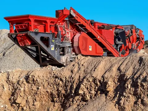 Tracked mobile crusher on a quarry stockpile